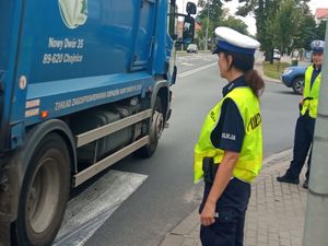 Policjantka wraz z policjantem z ruchu drogowego stojący przy przejściu dla pieszych