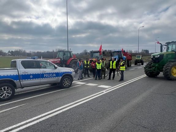 Policyjny radiowóz stojący obok protestujących rolników na obwodnicy Chojnic.