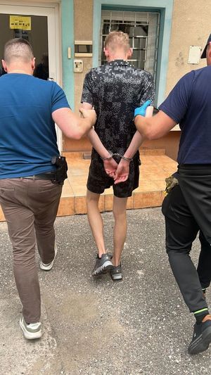 Policjanci prowadzacy zatrzymanego